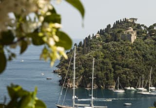Fringed by clematis, the balcony stands above a steep hillside, giving uninterrupted views of Portofino Harbour and its yachts