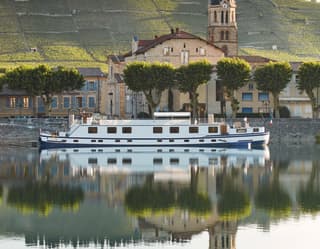 The Napolean cruises the calm River Rhône, which reflects Tain-L'Hermitage and its famous Côtes du Rhône vineyards beyond.