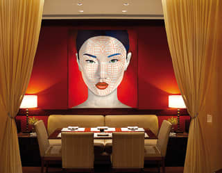 Contemporary portrait of an asian lady hanging above a restaurant table