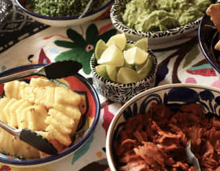 Bowls of pineapple, lime, guacamole, refried beans and cilantro add zest to a Mexican tacos feast at  Restaurant del Parque.