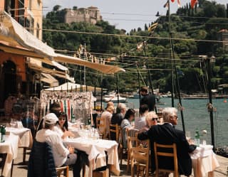 persone che pranzano e si rilassano sulla piazzetta di portofino