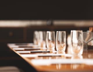 Polished glasses, sharpened Belmond pencils and blank paper pads on the table in the Santa Ynez meeting room