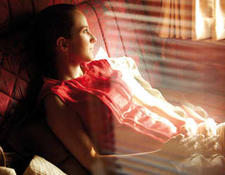 Lady reclining on a day bed in a luxury train cabin