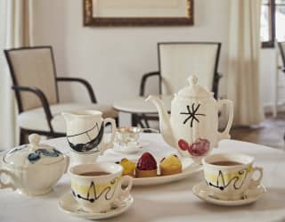 Close-up of a Miró porcelain tea set served with afternoon tea cakes