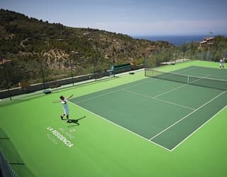 Tennis players on an outdoor court at La Residencia