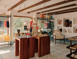 The boutique's beautiful clothing collections and home accessories by local designers adorn alcoves, shelves and teak tables.