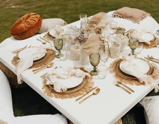dinner set up on a low table in a garden