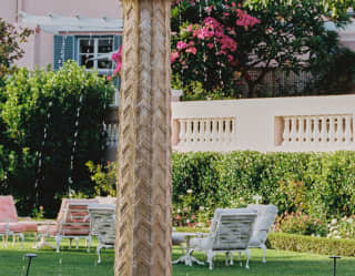 The unique fountain at Mount Nelson Hotel features a carved pillar topped with an ornate stone ball with lions' mouth spouts.