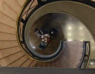 Birds-eye-view of a spiral staircase leading to an elegant lobby