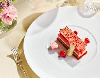 Looking down on a La Rhubarbe pudding with poached Yorkshire rhubarb served in a mille-feuille slice with a pink crisp top.