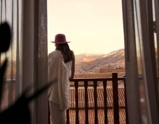 A lady standing at the suite's balcony