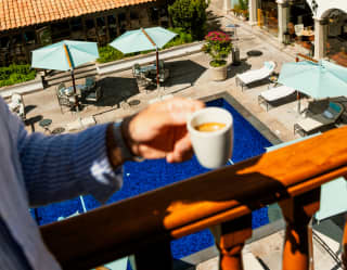 A lady standing at the suite's balcony