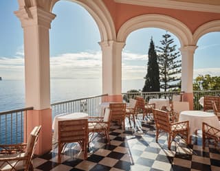 In a corner of the tea terrace's three-sided balcony, tables are placed along the railings for sublime, panoramic sea views.