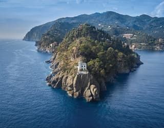 Boat approaching a rocky bay near Portofino