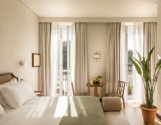 Light and airy hotel suite with parquet floor, and floor to ceiling windows