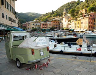 Sage green Italian Ape Calessino car with a 'just married' sign on the back
