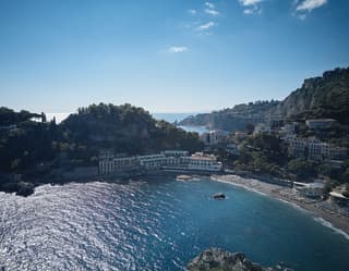 Belmond Villa Sant'Andrea on the shore of Taormina bay under blue skies