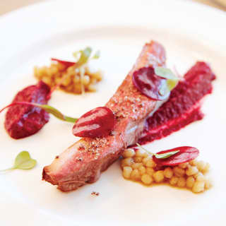 Close-up of a beef carpaccio garnished with chickpeas