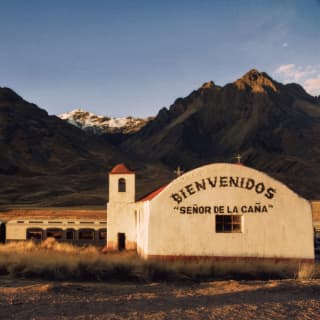 The Andean Explorer stopped near an old church in La Raya with the inscription Bienvenidos 