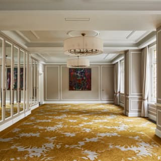 The light-filled Oscar and Lillie rooms comprise flowing gold and white carpet, grey walls, mirrored panels and artworks.