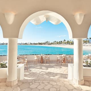 Sunny restaurant terrace overlooking the Caribbean Sea