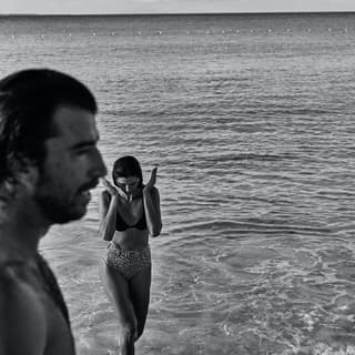 Black and white photo of a couple stepping out of the Caribbean Sea
