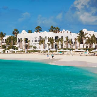 A row of white-domed villas on a sandy beach in Anguilla