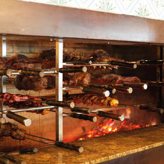 Skewers of various meats cooking in a large barbecue oven at the hotel’s speciality Ipe Grill