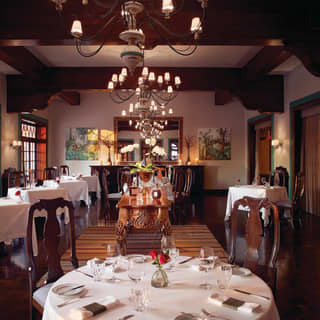 Elegant restaurant with wood-beamed ceiling and dark wood furniture