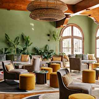 With green walls, potted plants and low seating in taupe and mustard, Restaurant Y's lounge offers naturally elegant comfort.