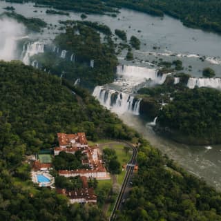 The hotel sits at the edge of dense forest, a stone's throw from the terraces of the dramatic Iguassu Falls, seen from above.