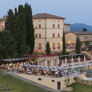 See from above, diners enjoy the romance of evening lights at Tuscan dusk under the al-fresco canopies at the Pool Grill.