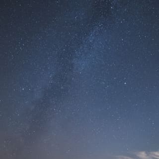 The Milky Way snakes across the heavens, a cloudy ripple in the darkness marking our galaxy among an ocean of stars