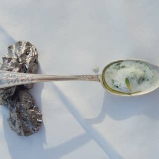 A taster of the classic Venetian dish, baccalà mantecato – creamed cod – sits on a silver spoon on a white table cloth