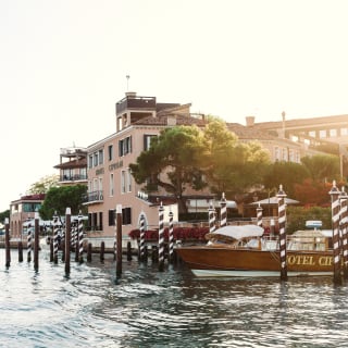 Exterior of Belmond Hotel Cipriani from across the lagoon at sunset