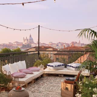 Rooftop party venue with comfy banquette seating and views of the Venice skyline