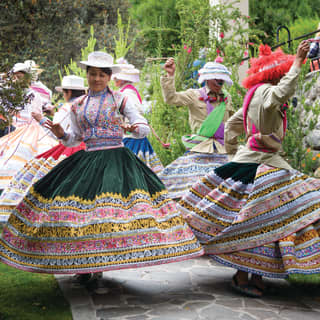Dancers in traditional Peruvian dress whirling in the gardens of Las Casitas