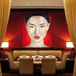 Contemporary portrait of an asian lady hanging above a restaurant table