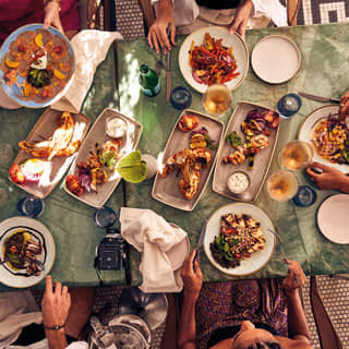 An overhead shot of people sitting around a dining table at Pérgula restaurant