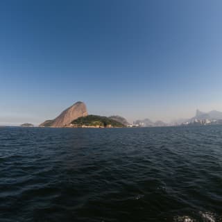 Mountains rising along the Rio de Janeiro coastline, viewed from across water