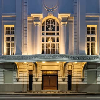 A marble awning and grand pillars mark the entrance to one of Rio's most glamorous venues, the Copacabana Palace Theatre