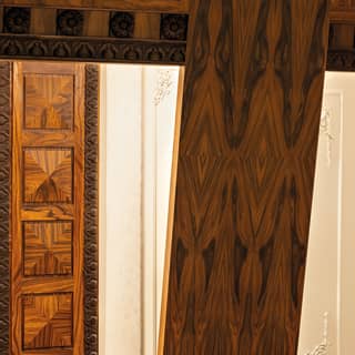 Close-up of walnut wall-panel detailing with carved trim detailing