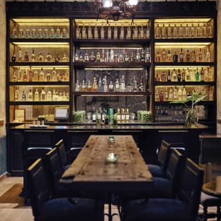 Elegant bar area with rows of tequila bottles on mirrored shelves
