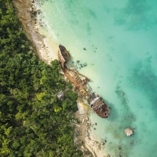 Birds-eye view of a shipwreck in crystal clear waters