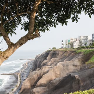 The wavy cliffs of the Lima shoreline with a curvy road sweeping along the base