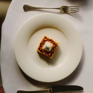 An Afternoon Tea dessert of pecan praline, Dulcey ganache, jasmine tea whipped ganache and candied pecan, seen from above.