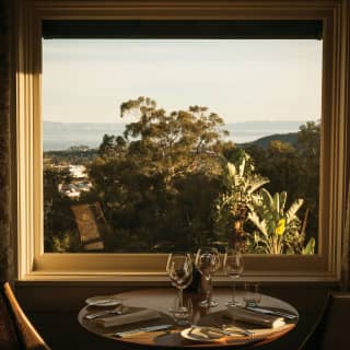 Restaurant table with views across Santa Barbara through windows beyond