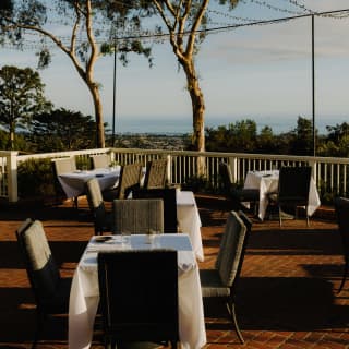 Tables sit in soft sunshine on the terrace, overlooking Santa Barbara's Eastside, with views of the North Pacific ocean.