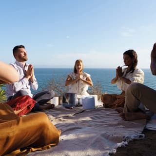 Guests experience a soothing sound bath meditation with guru Cristy Candle alongside  the Pacific Ocean waves