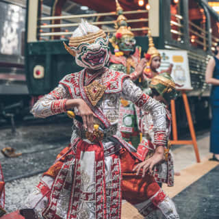 Traditional Thai dragon dancers outside a luxury train carriage
